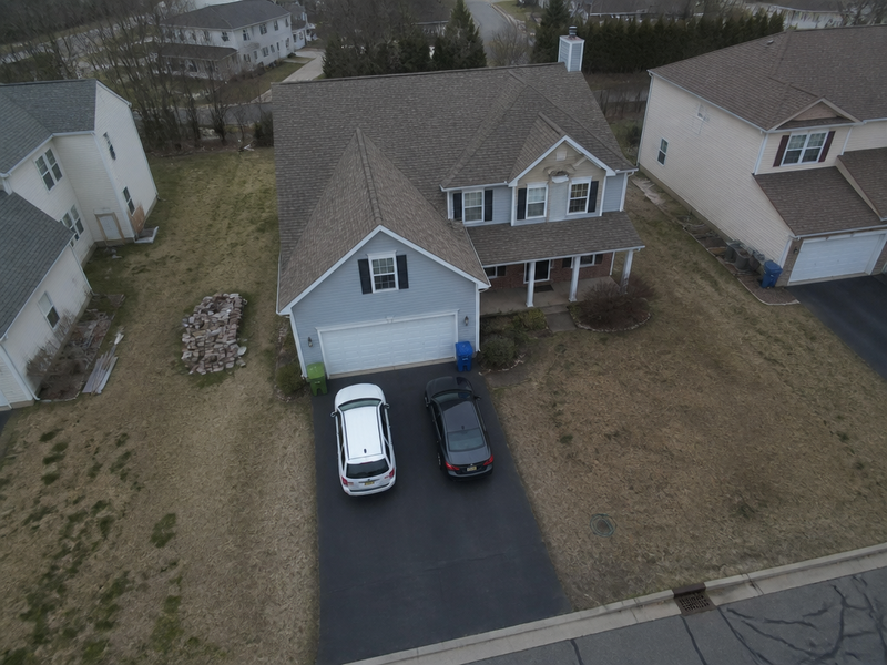 A drone exterior with hazy sky and flat colour brought to a clean aerial frame. — before