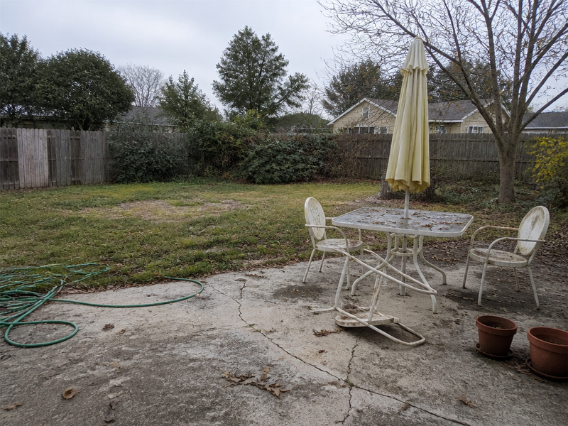 Before — A redesigned backyard with a patio and fire pit on the same property.