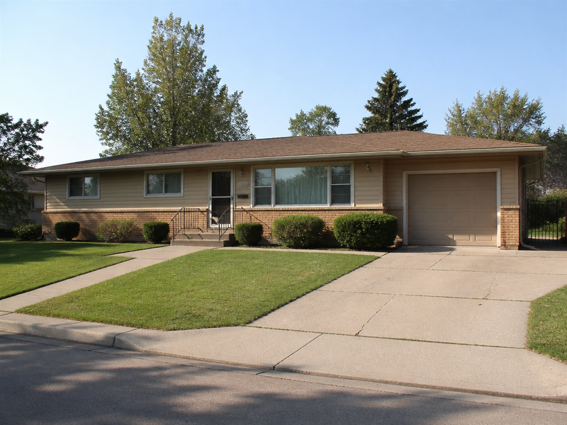 Before — A rendered house exterior with sited landscaping.