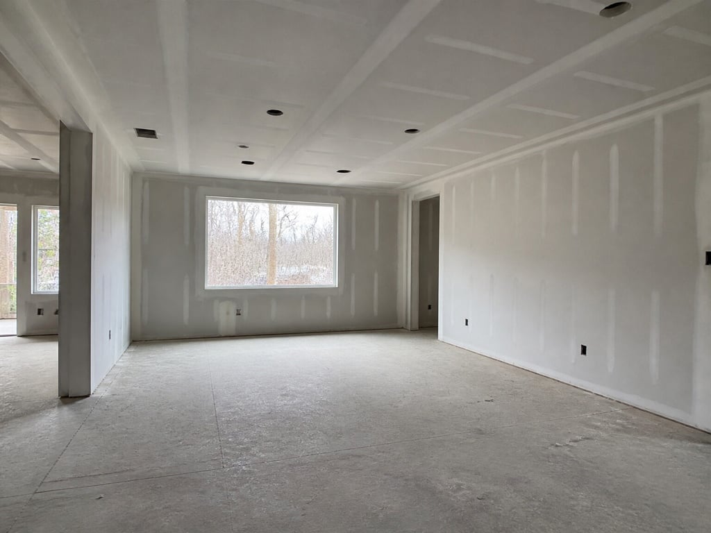 A bare under-construction room rendered into a furnished, photorealistic living space. — before