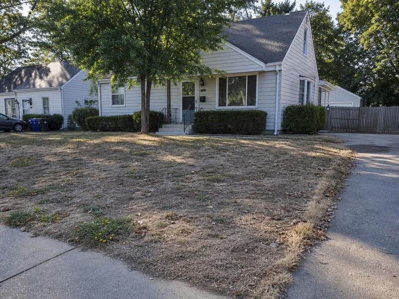 Before — A house with a brown lawn replaced by a green one.