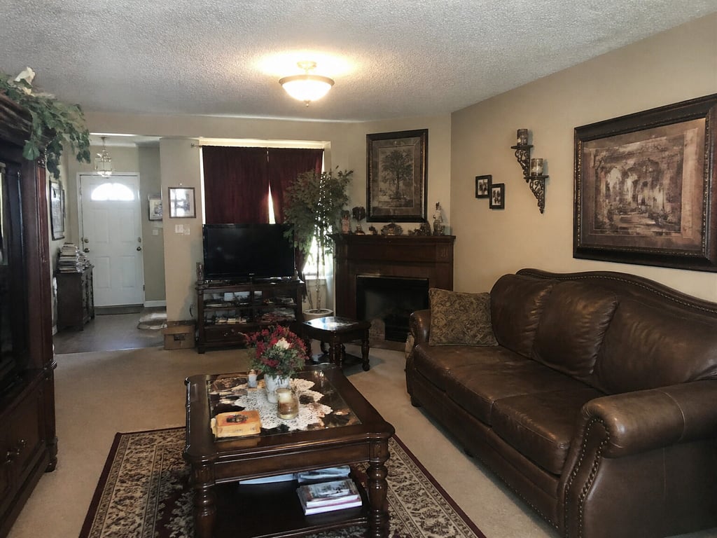 A furnished living room restyled into a new interior design style, layout unchanged. — before